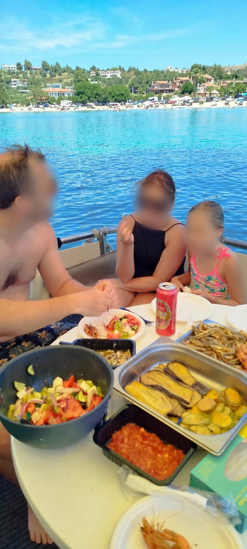 Friends sharing a barbecue meal aboard with faces privacy-protected