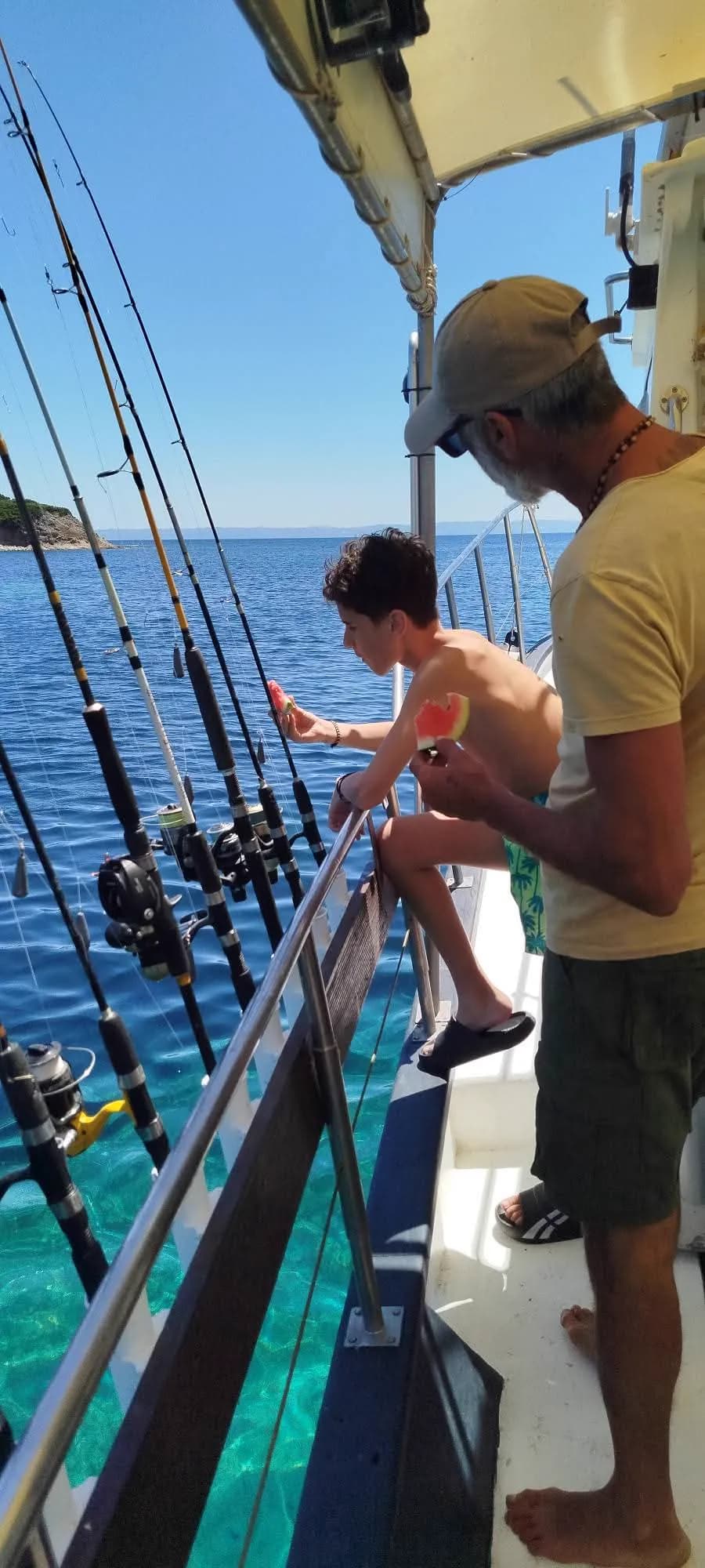 Our crew beside the fishing rods on the boat
