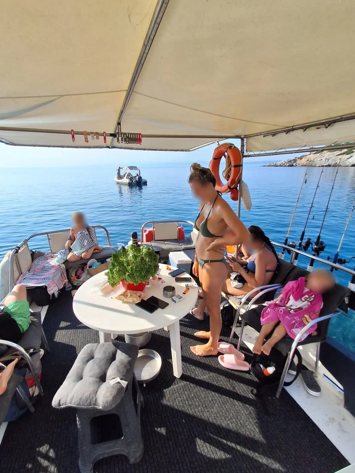Guests resting on the shaded deck between stops, faces privacy-protected