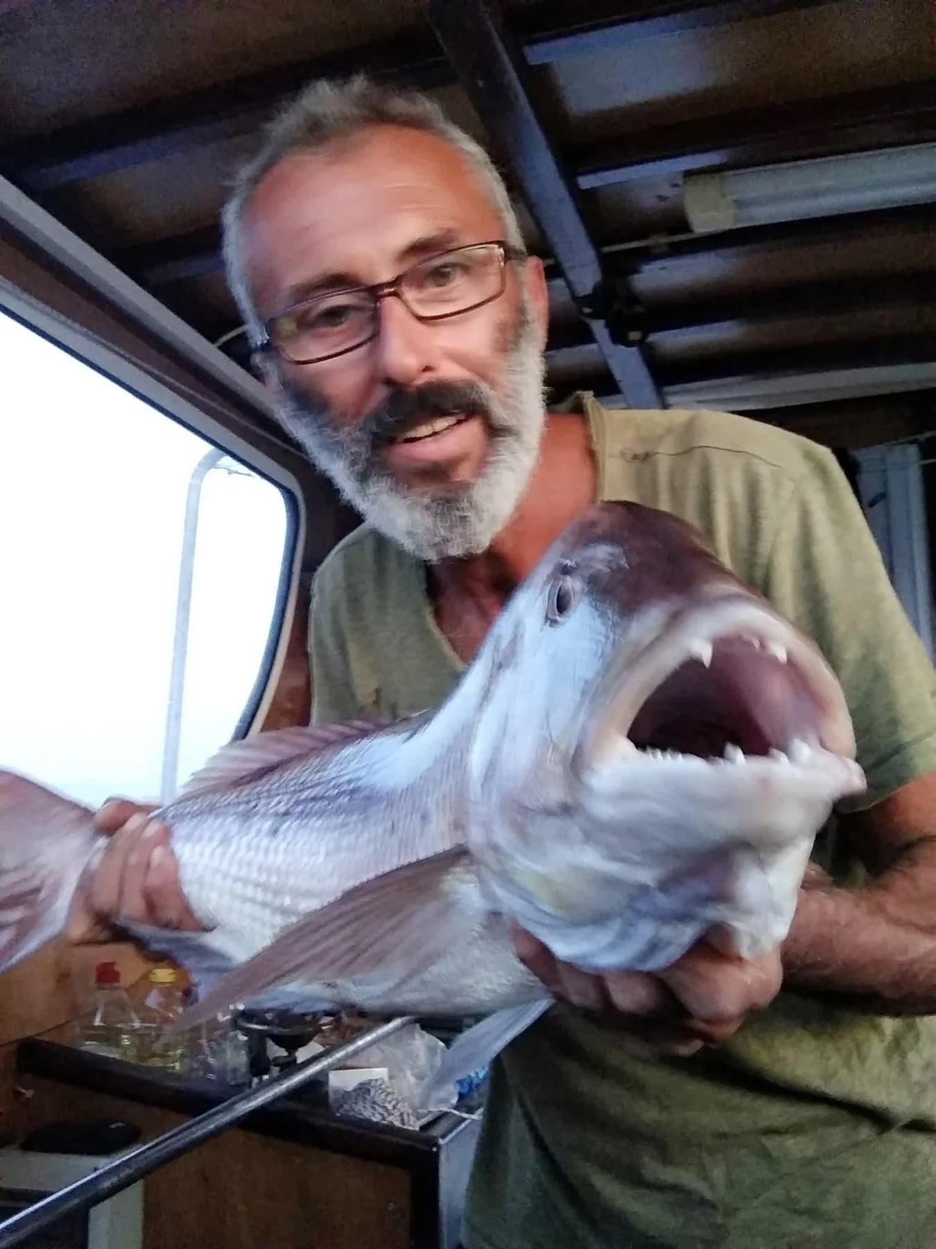 Dimitris holding a large fish aboard