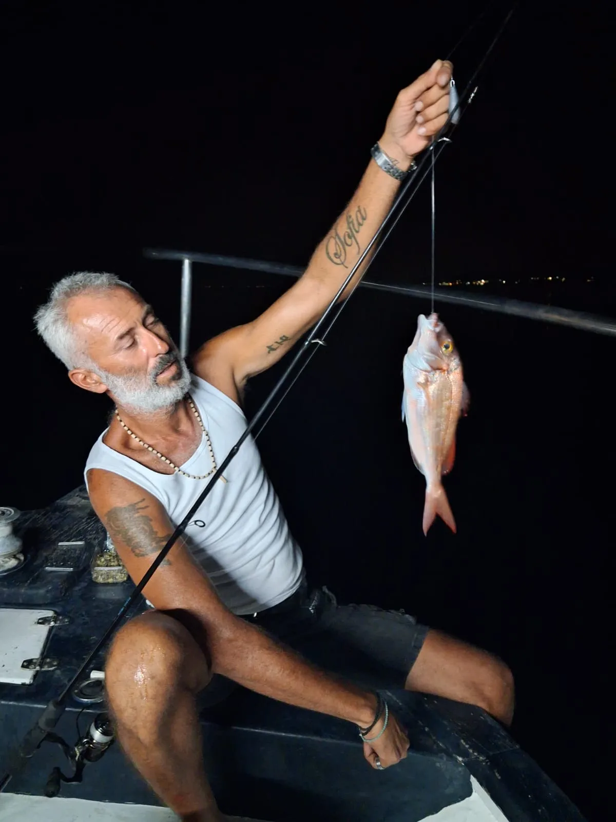 Dimitris holding a pandora he has just landed during a night trip
