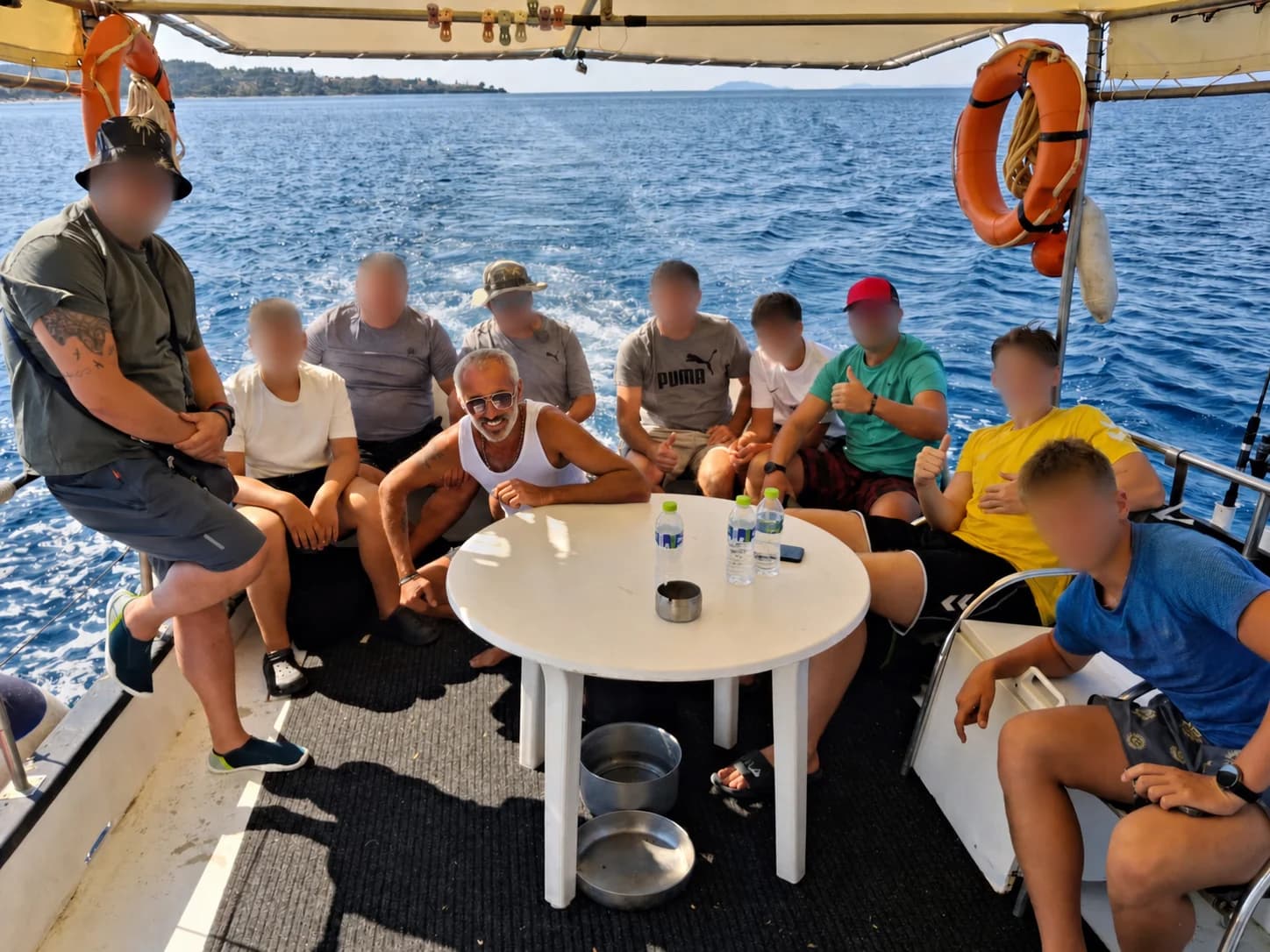 A group enjoying a fishing day at sea with faces privacy-protected