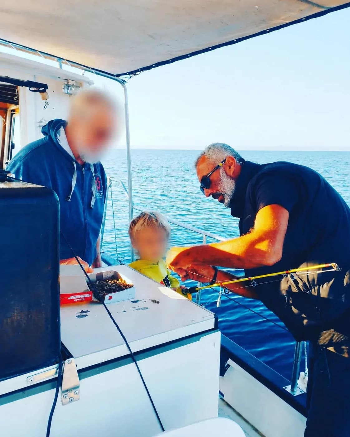 Dimitris helping prepare fishing tackle aboard