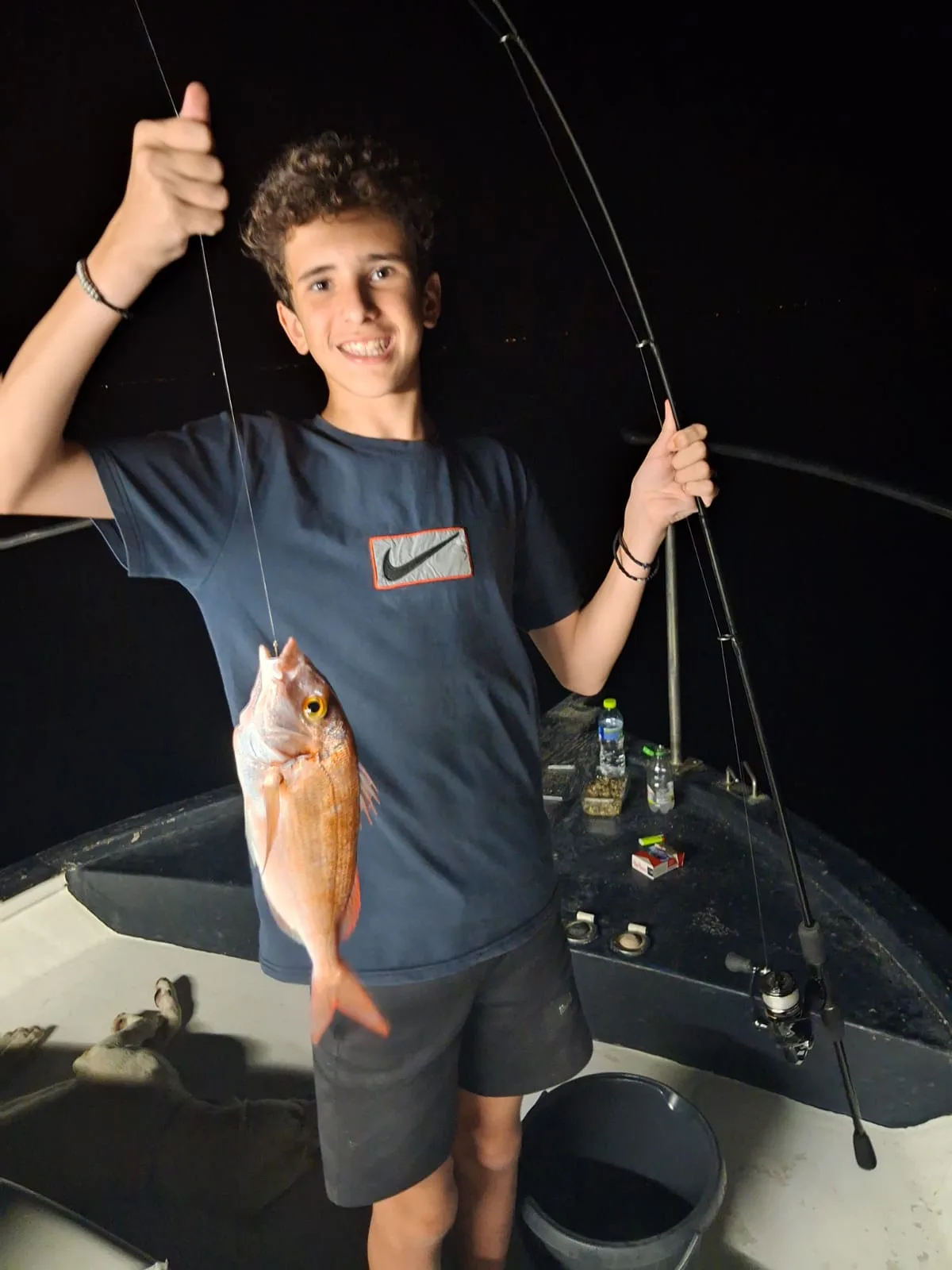 Dimitris' son holding a pandora caught on a night trip